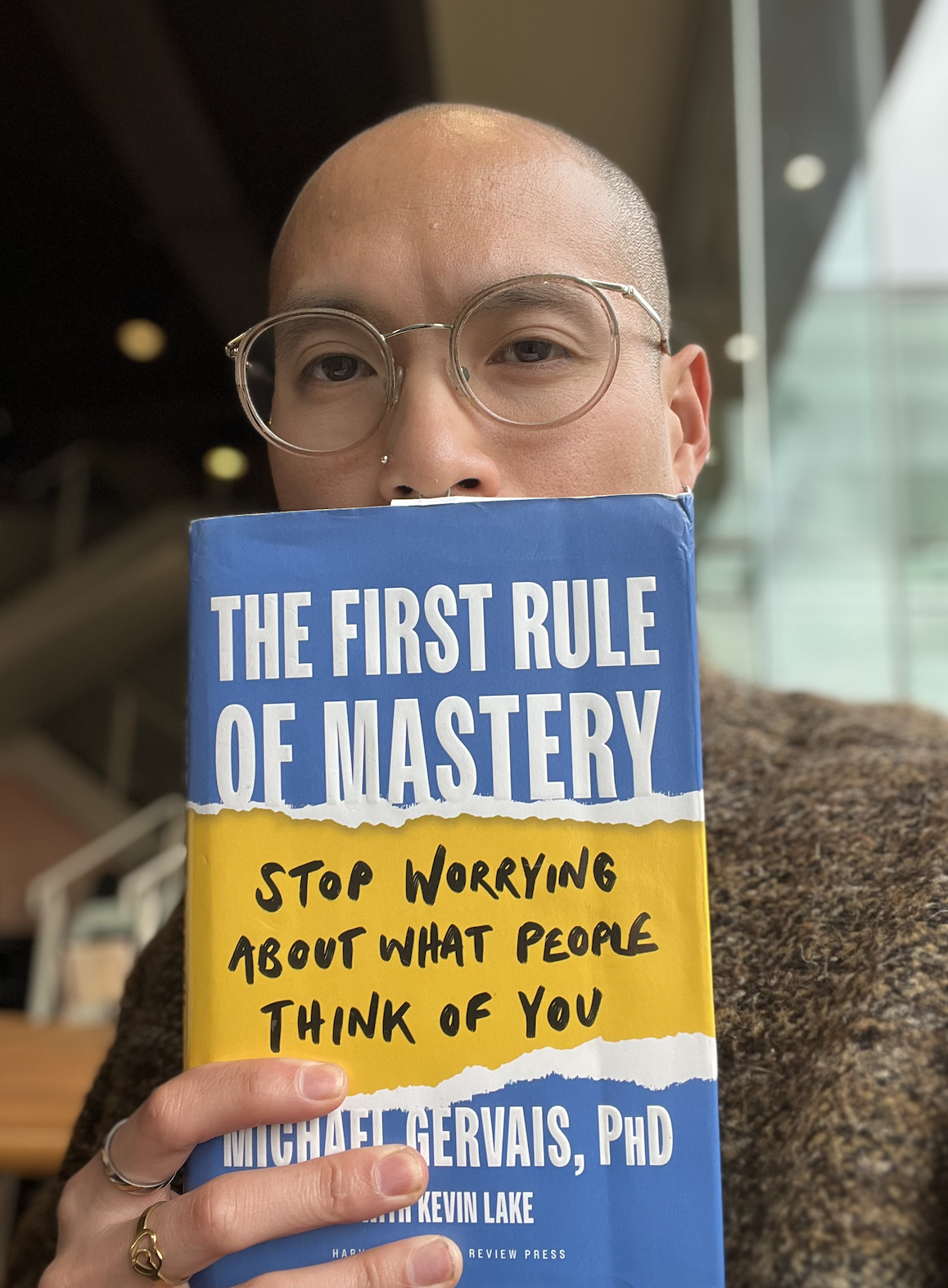 Selfie photo with me and the book "The first rule of mastery: stop worrying about what people think of you"